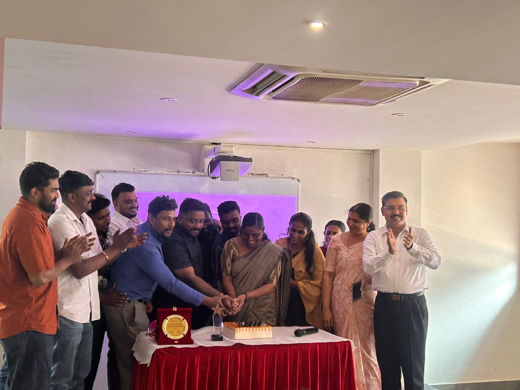 Team members cutting a cake during office celebration